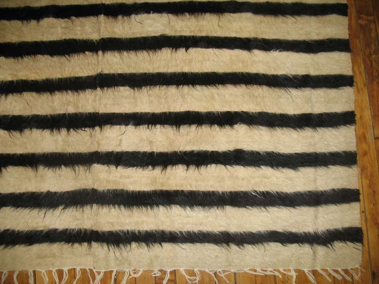 An Authentic Indian mohair rug in ivory and black. Can be used as a blanket or a throw piece to lay out on a piece of furniture.

5'1'' x 6'10''