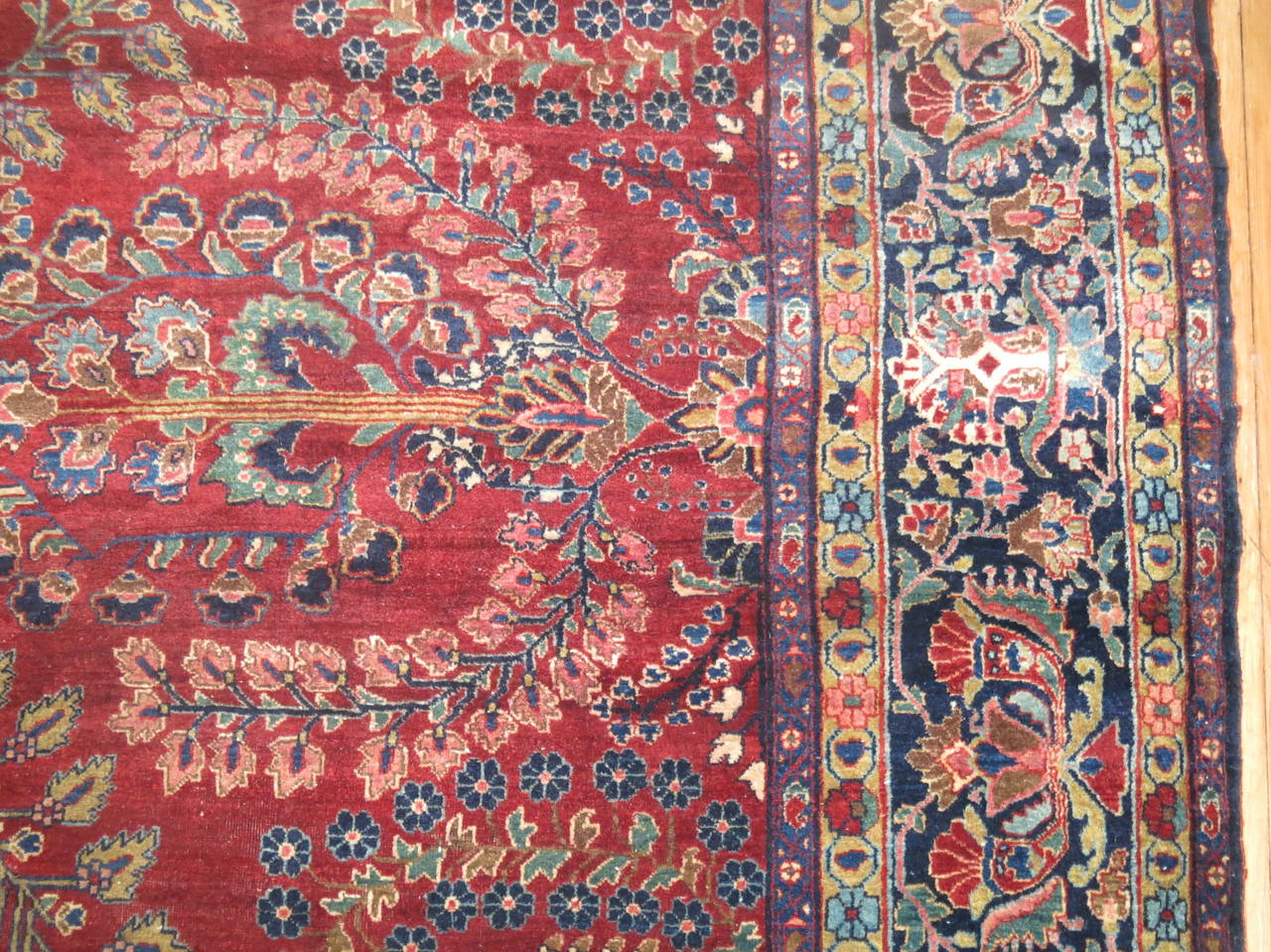 Early 20th century Persian Sarouk Fereghan rug in deep cranberry reds and blues.