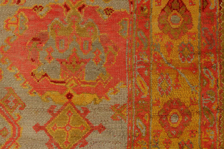 An antique Turkish Oushak rug featuring a silver shaded field, mustard border, with other vibrant and bright color accents. Truly divine and one of our personal favourites, circa 1920

Measures: 12'4