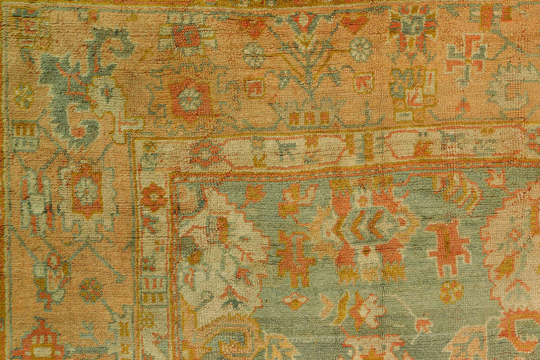 A late 19th-century antique Turkish Oushak in warm vibrant colors. Field is teal with lots of pink and orange accents
Pictures shown with flash and without a flash.
Measures: 11'10