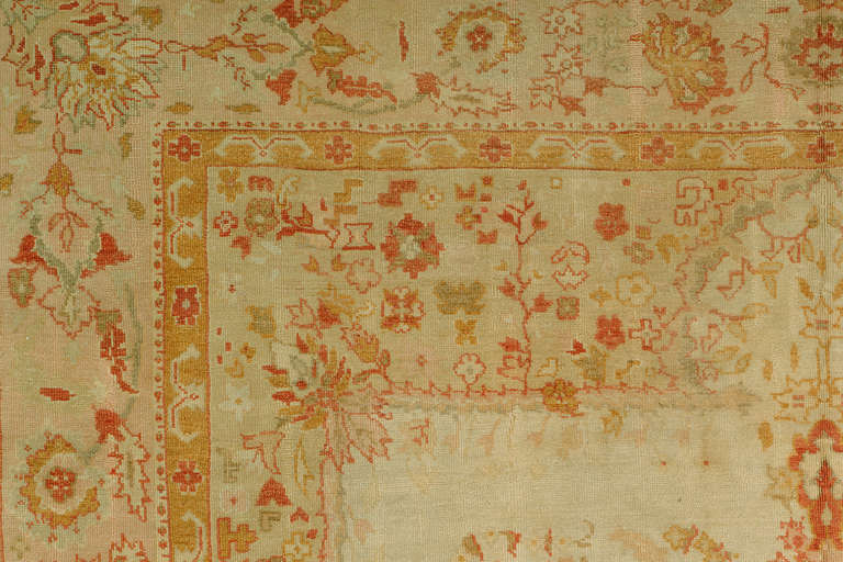 A jawdropping one of a kind floral antique Turkish ivory Oushak rug. Rug is in excellent shape and has thinner nap and weave than most antique Oushak's around. Can be placed in many different formal or informal settings. absolutely no flaws and is a