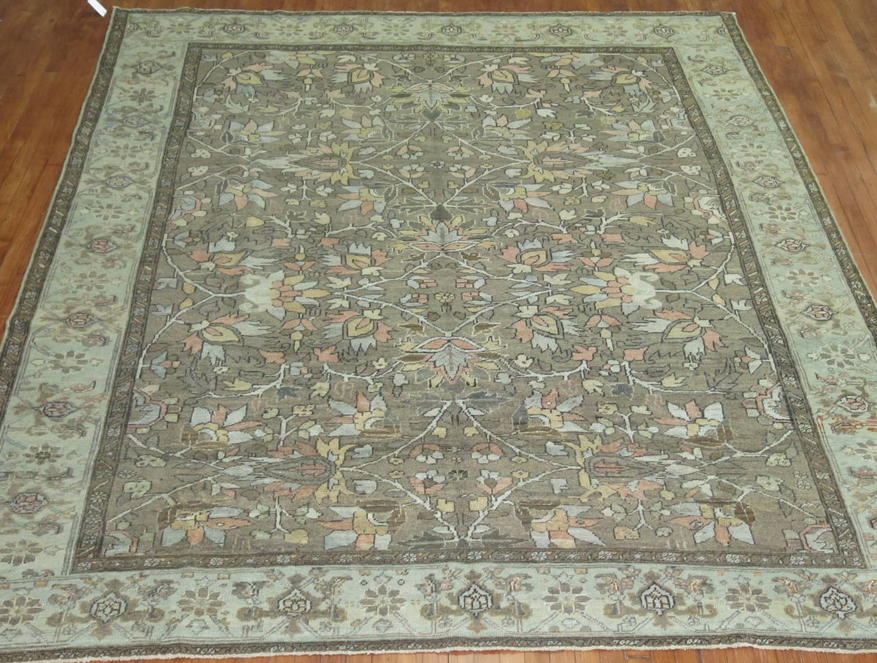 An early 20th century room size Persian Heriz in slates and charcoal.

Measures: 8'8'' x 11'1''.