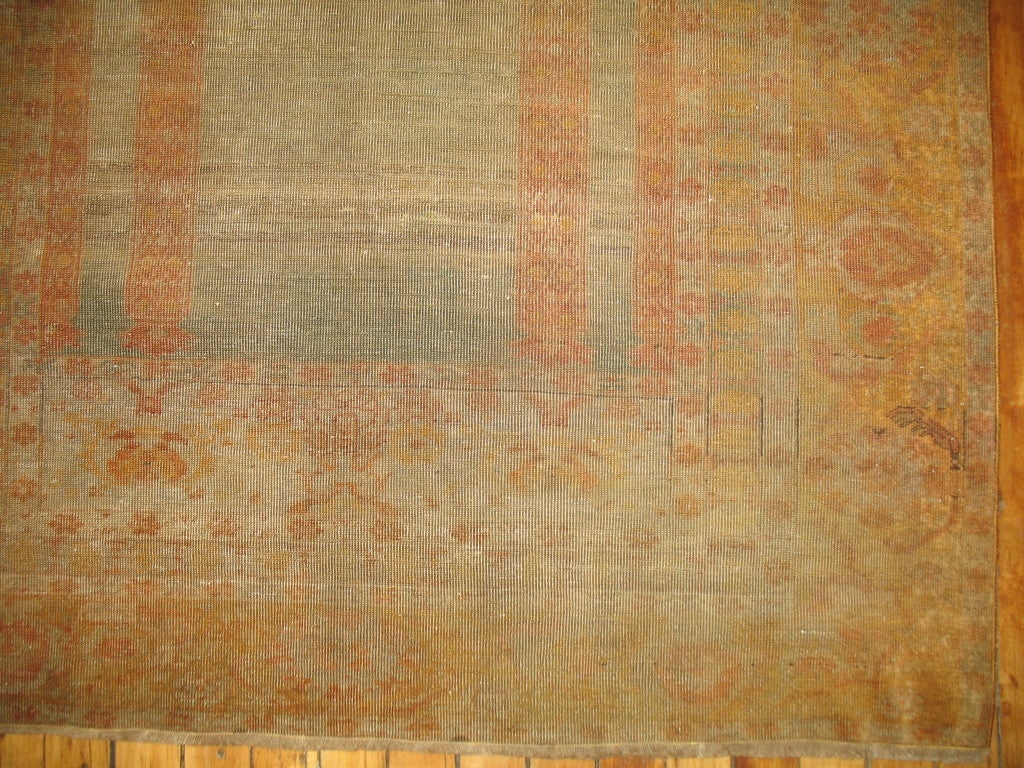 A superb small antique Turkish rug. Predominantly sea foam green and burnt gold giving it a faded, sublimed look.