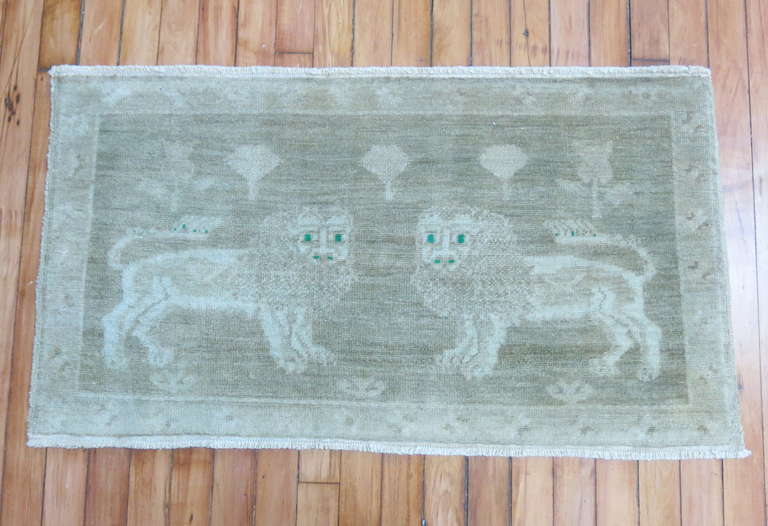A handmade Turkish rug featuring 2 lions staring at their owner  with emerald green eyes. We think it  would make for a great wall decor too