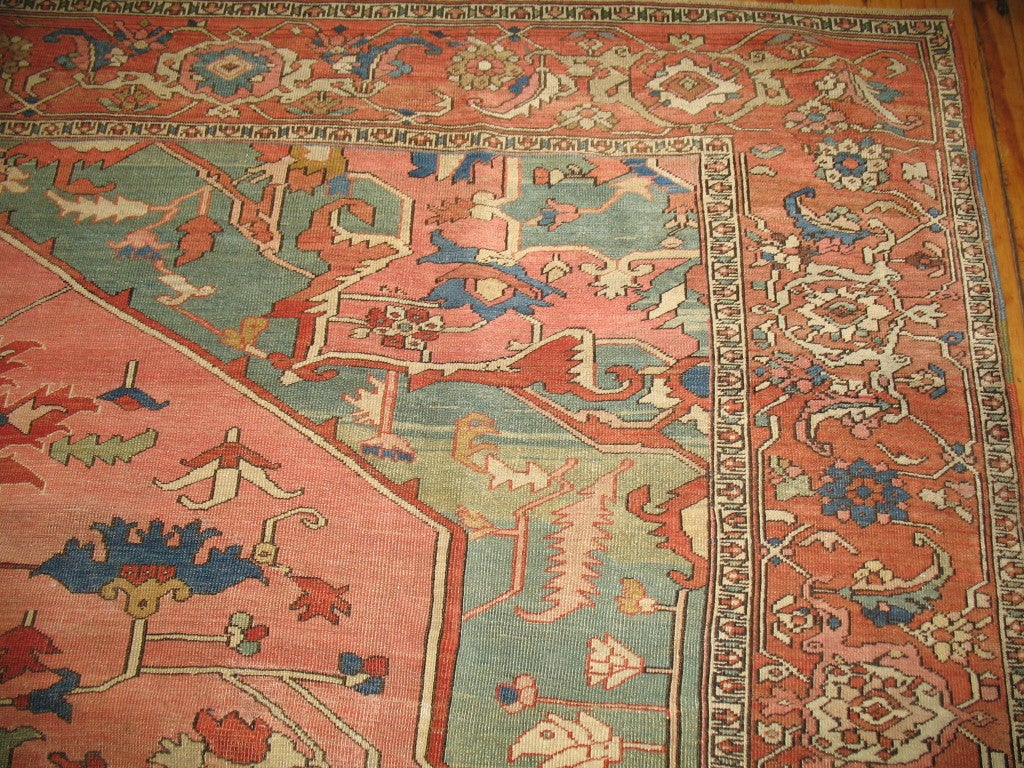 A gorgeous, authentic antique Persian Serapi. Pink ground with soft greens, shades of blues and rusts. The finest of qualities from this workshop.