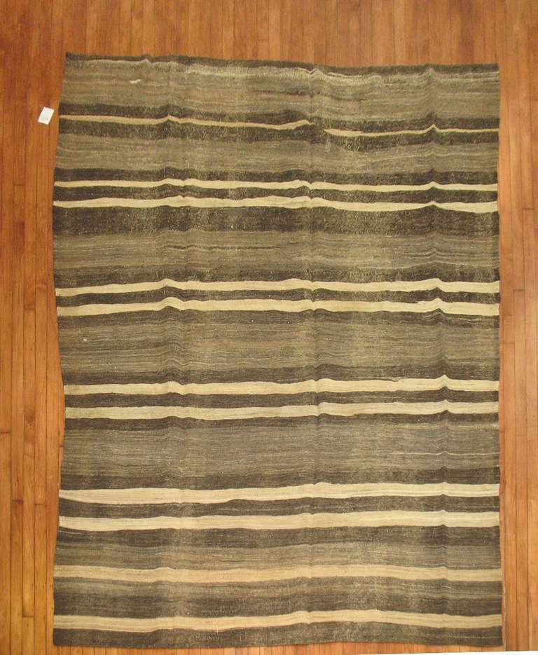 A midcentury Turkish Kilim. Charcoal, brown, ivory.

Measures: 7'2
