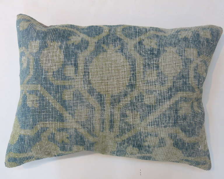 A Pillow we made from a 19th century aqua blue and ivory antique khotan rug,measuring 16'' x 22''.