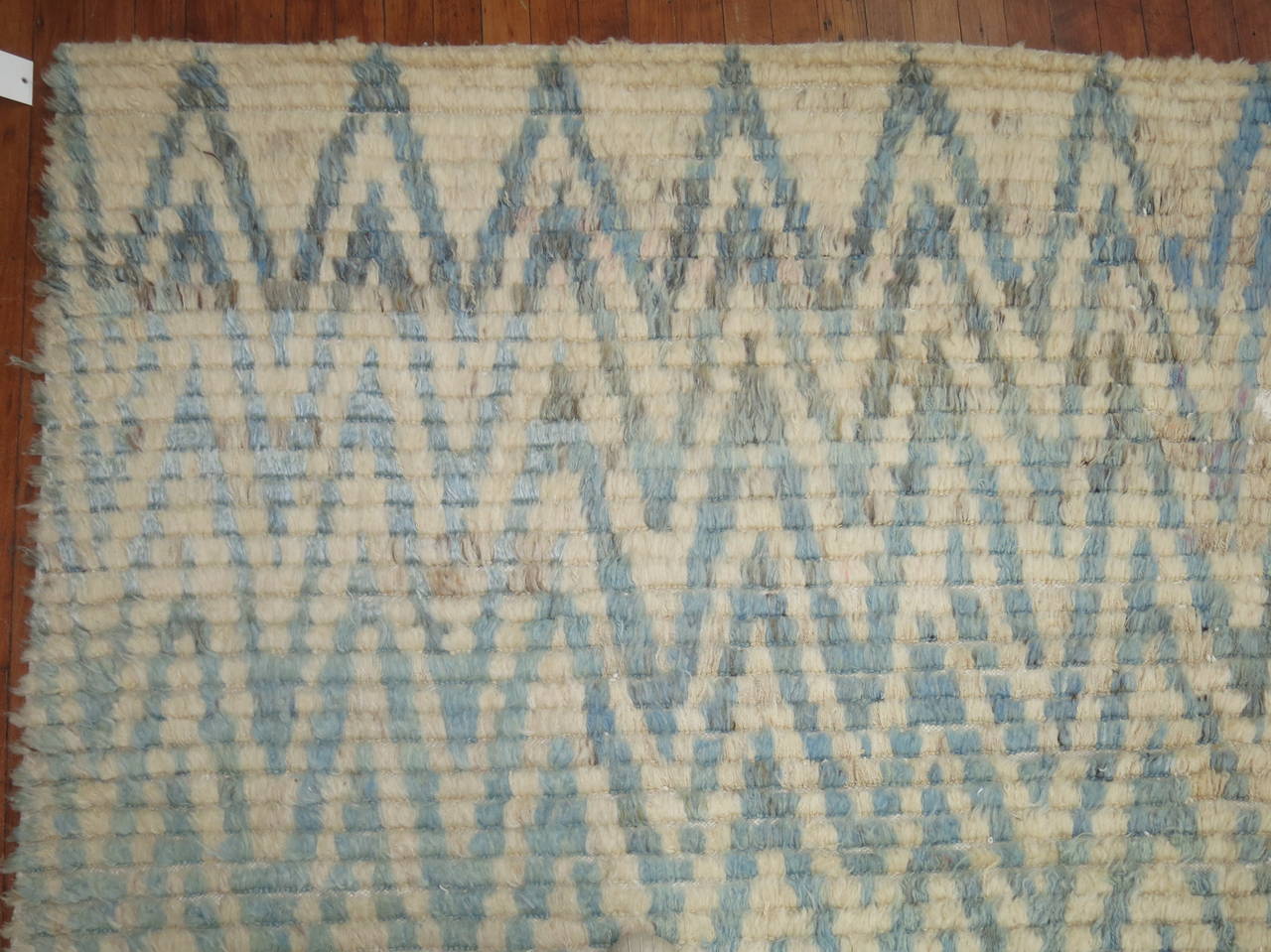 A one of a kind Turkish Tulu plush shag rug. Ivory ground with a chevron motif in shades of blue.