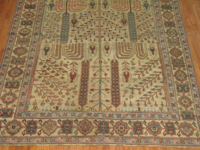 A tree of life design gives life to this beautifully constructed early 20th century antique Persian Bakshaish Rug. Camel field with earth toned accents.
Read below for a brief history of rugs from The Bakshaish region.

Bakshaish is a town on the