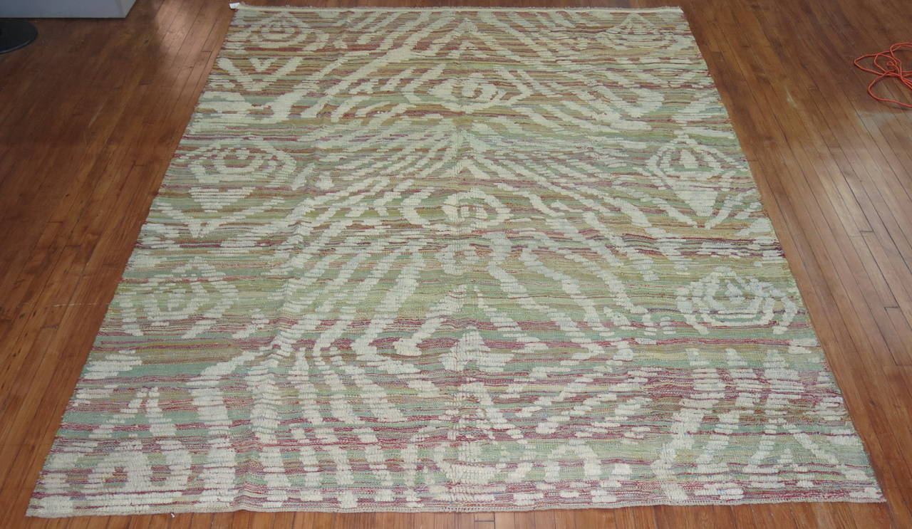 A one of a kind flat-weave carpet with a piled modern designed derived from old hand-spun wool used to make vintage Turkish Tulu rugs.

8'3'' x 10'6''