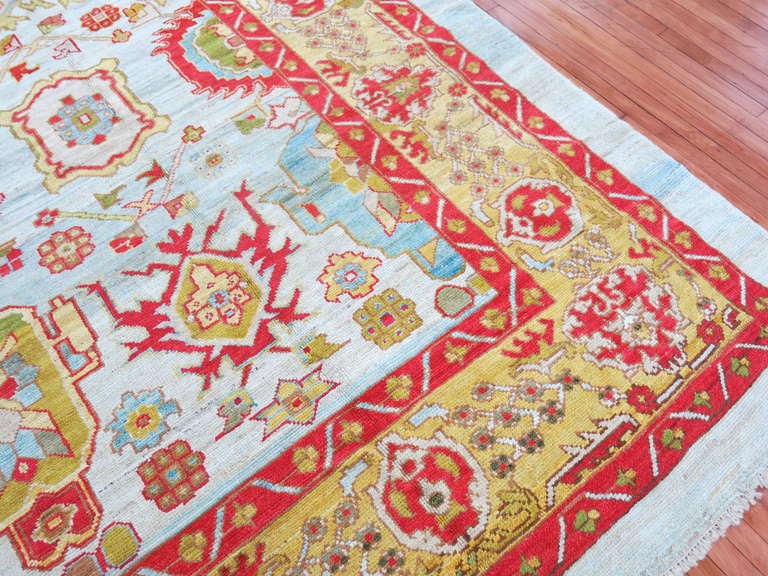 A dazzling turkish oushak rug in bright and happy colors.