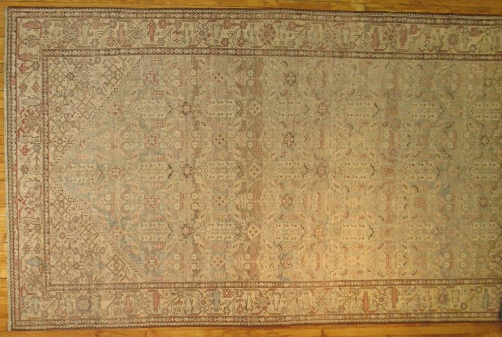 Rare size Persian gallery rug in earthy palette with faded abrashes.