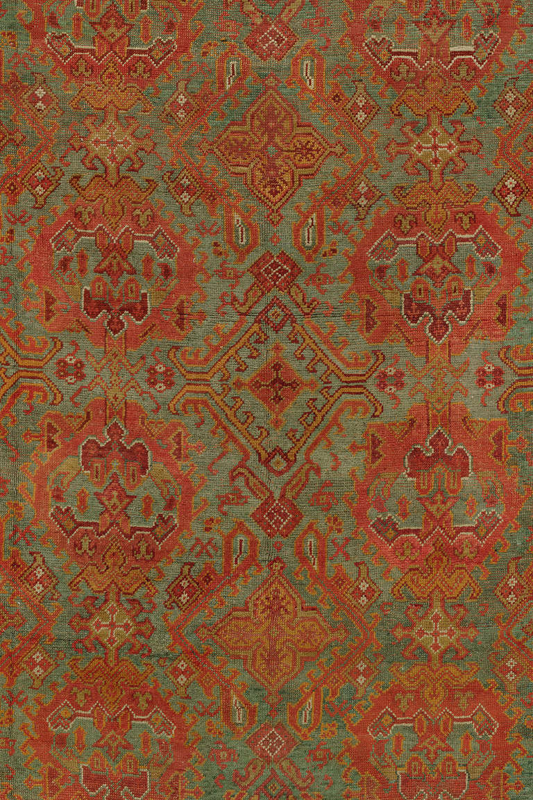 An early 20th century colorful palace size Turkish Oushak rug.