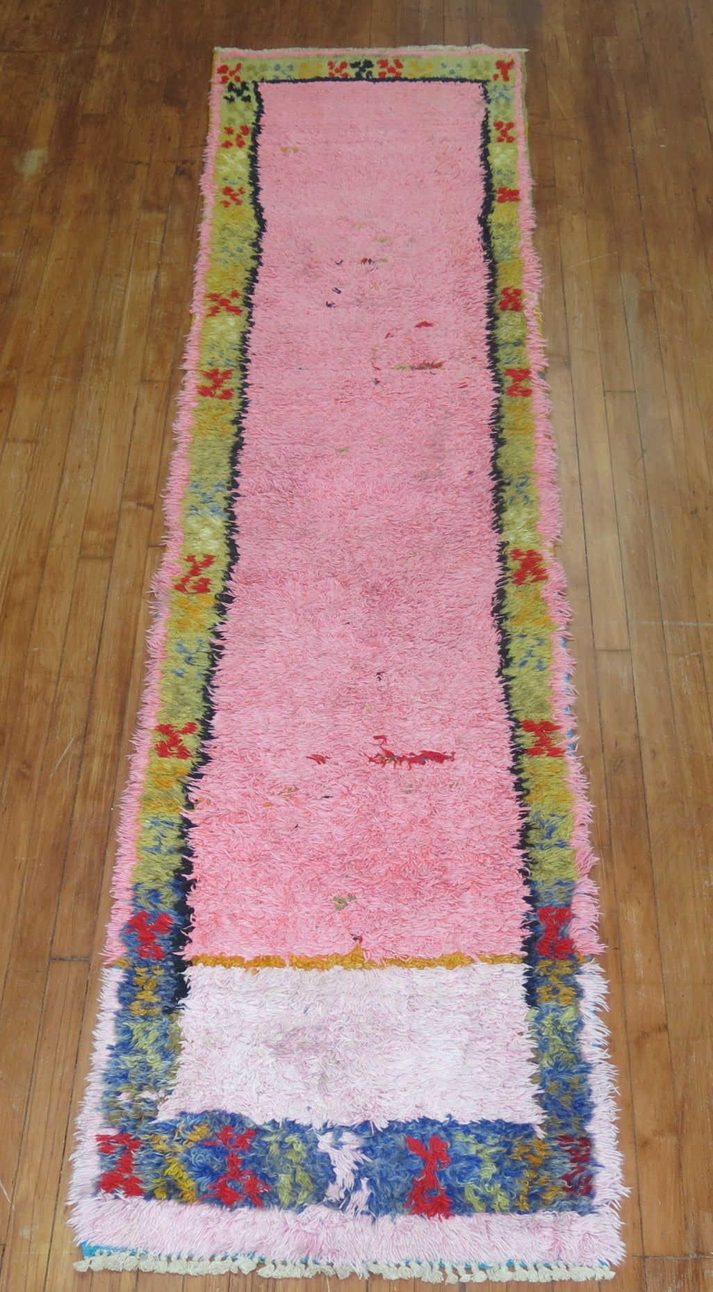 A rare one of a kind Turkish Tulu runner with a predominant bubble gum pink ground.

2'3'' x 9'6''