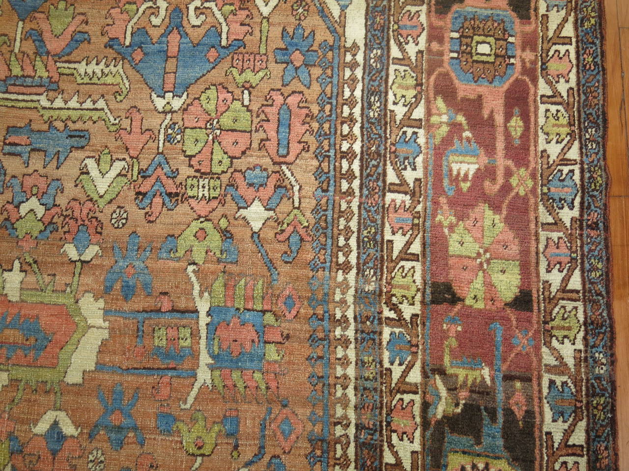 An early 20th century one of a kind in rustic tones. Pretty browns, light blue, green, and mustard dominant accents.

Measures: 12'4'' x 17'9''

The virtues of antique Heriz carpets are found in their design style and color. The signature of a