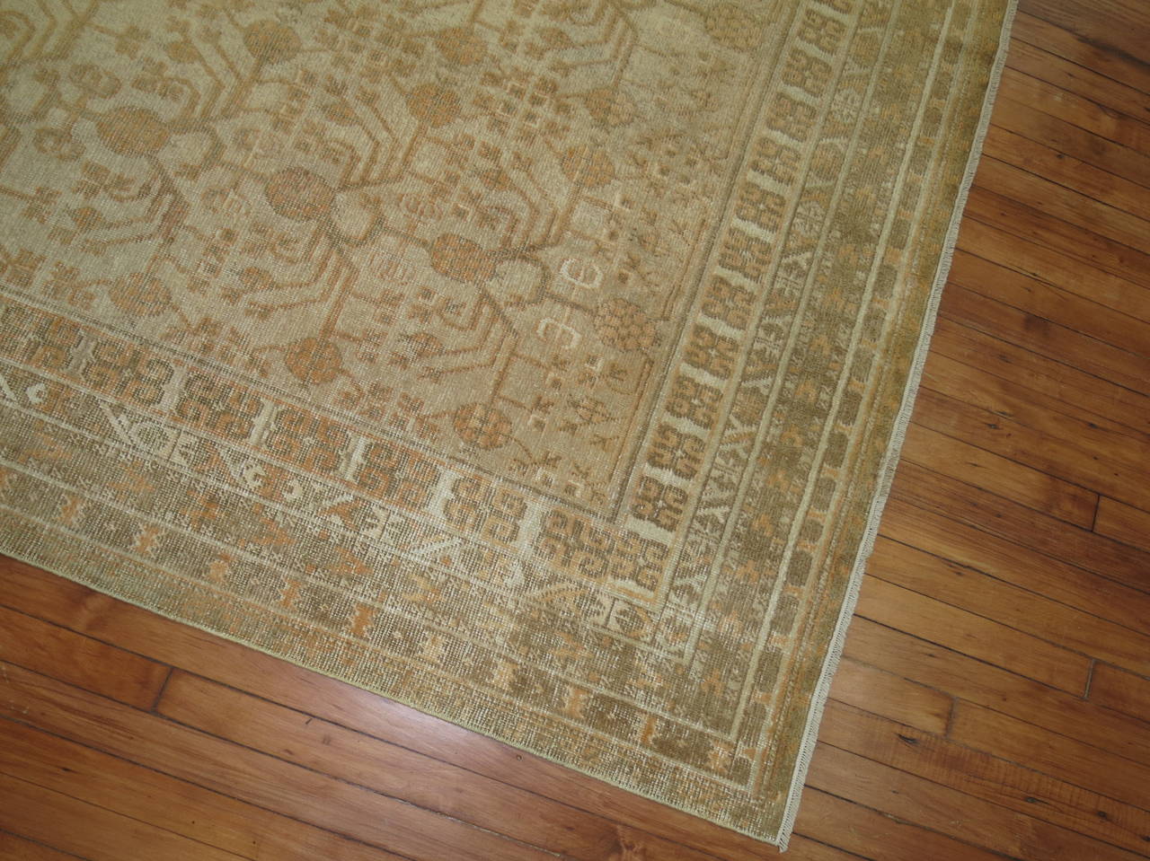 An early 20th century Khotan rug in camels, ivory and brown.

5'7'' x 10'4''