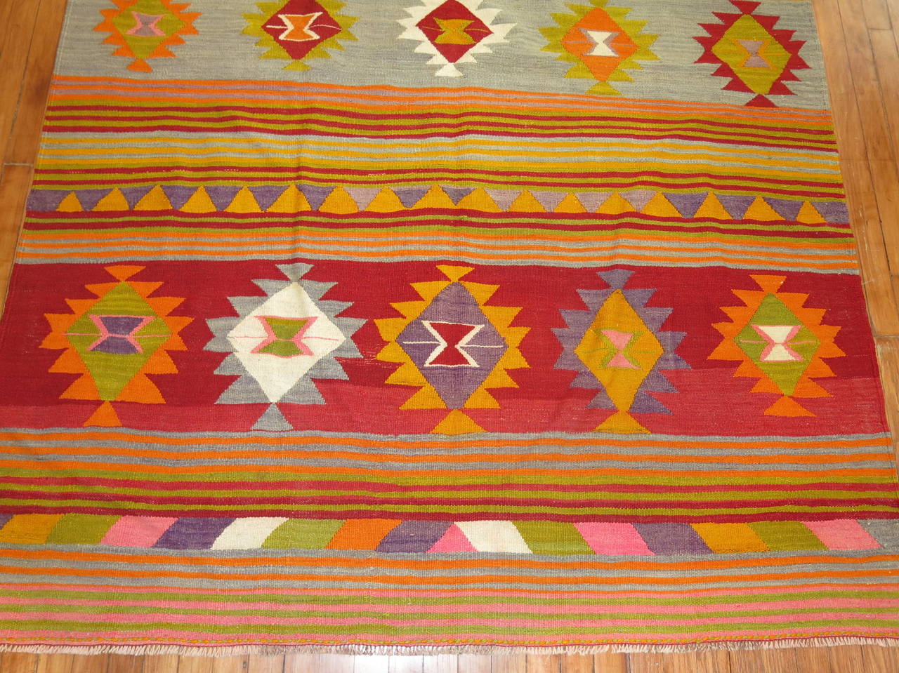Cheerful one of a kind intermediate size Turkish Kilim flat-weave. Love the bright pinks that pop up 

Measures: 5'6'' x 8'.