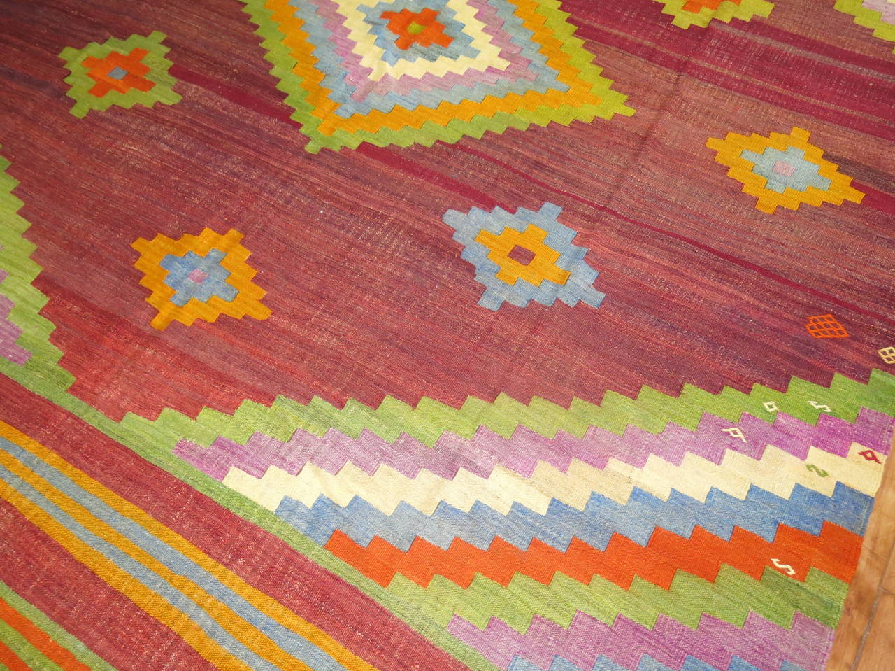 A cheerfully colored mid-20th century handmade room size Turkish Kilim.

9' x 10'11''