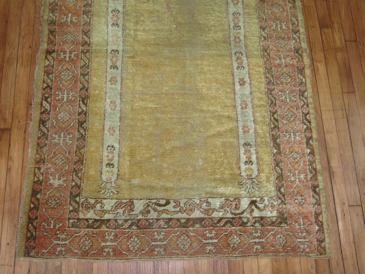 Late 19th century angora wool Turkish Oushak. The field is a soft yellow. The border is a melon color. 

Measures: 4' x 5'9