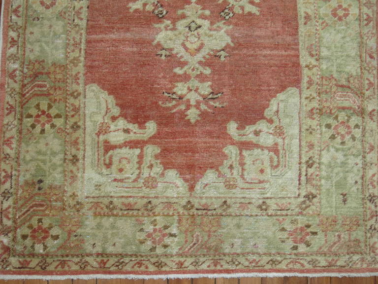An early 20th century scatter size angora Oushak rug.