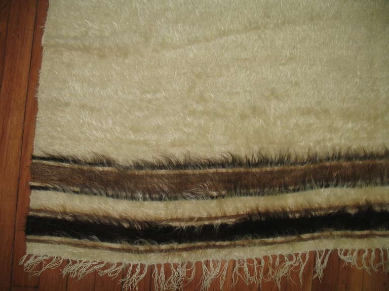 A mid-20th century Turkish Mohair rug that can also be used as a rug or even a wall hanging. Ivory, browns and black.

Measures: 4'8