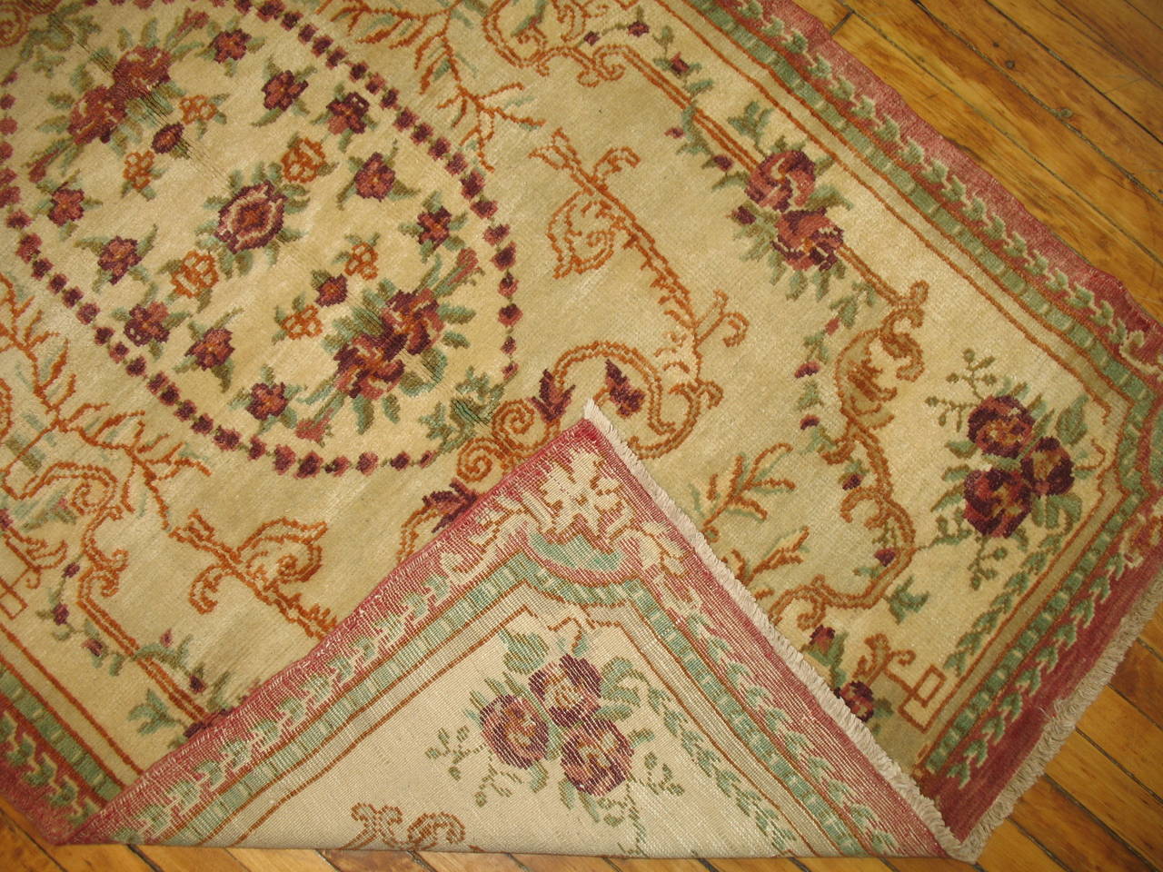 Exquisite Turkish ghiordes weave. Ivory field with splashes of raspberry and celadon green.