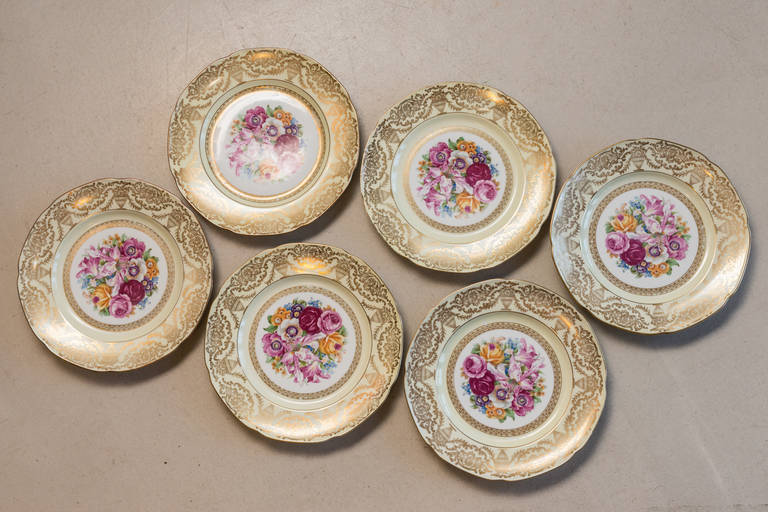 Set of 6 Porcelain pale yellow Dinner plates with floral center on white background