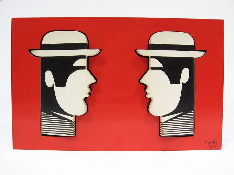 This delightful piece by Greek artist Yannis Gaitis (1923-1984) features a pair of his iconic anonymous men in hats. The heads are hinged and open to reveal a negative cut-out in a shallow box. 

Equal parts painting and sculpture, the interactive