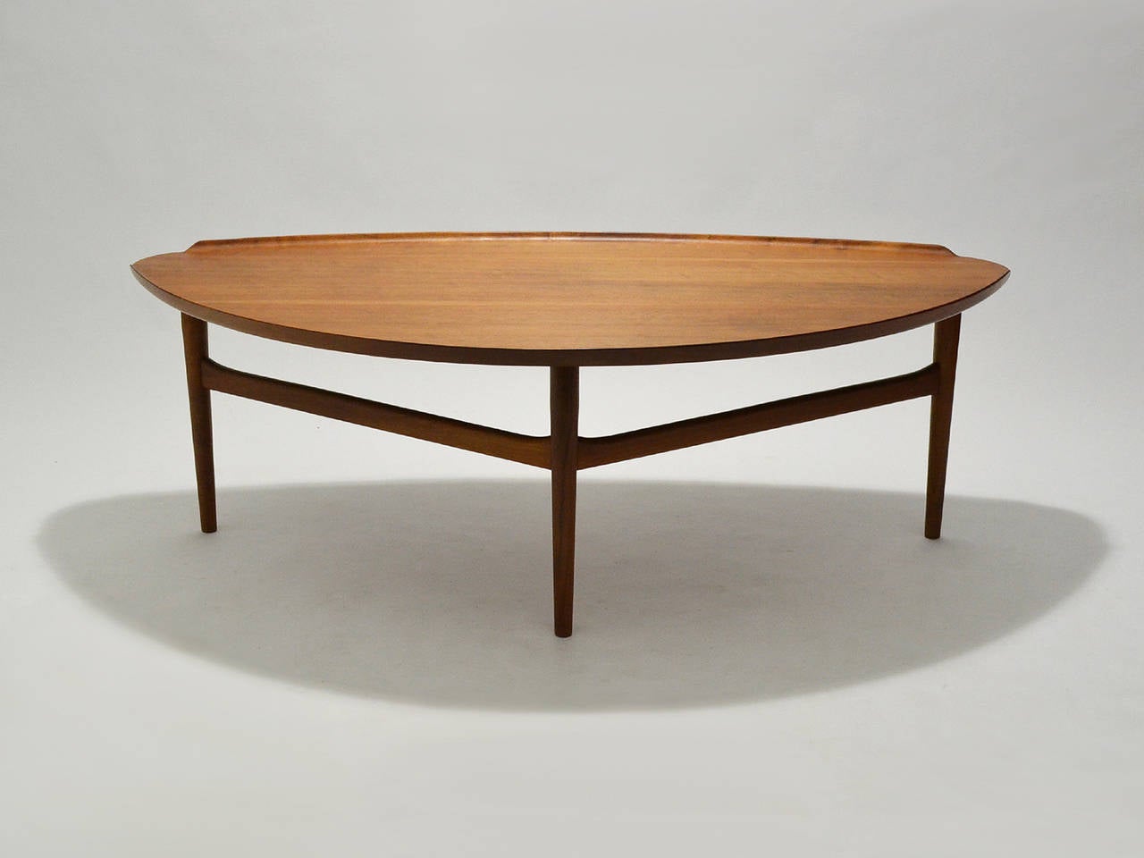 Designed by Danish master Finn Juhl and crafted by Baker Furniture in the US, this large coffee table is exquisite.

Finn Juhl was skeptical that any American manufacturer could produce his designs to his exacting standards. After visiting Baker