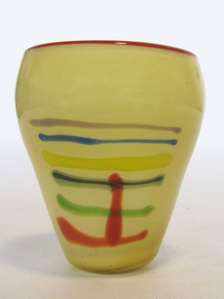 This large art glass vase with a great linear design in vivid colors is sadly, unsigned. However the quality and visual strength of the piece speaks for itself.