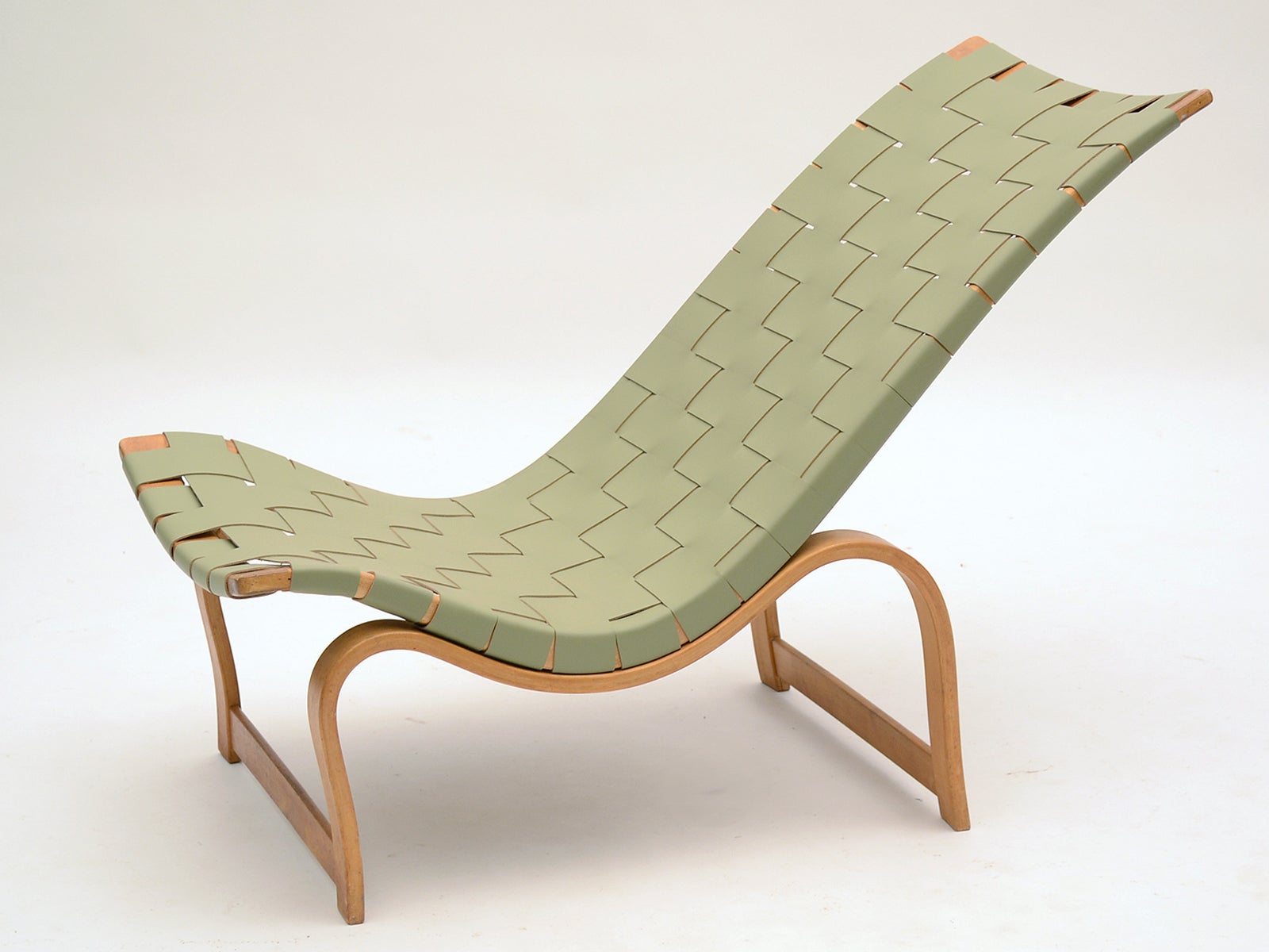 Among the earliest of Bruno Mathsson's designs is this rare model 36 easy chair. It features interesting details that were changed in later production. The legs are uniform in thickness rather than tapered and the stretchers are low on the legs near