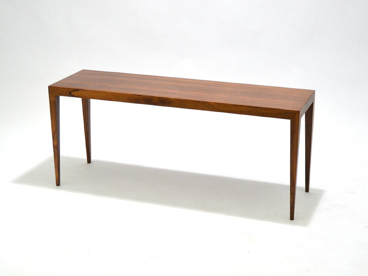 This lovely table by Severin Hansen is noteworthy for its richly figured rosewood as well as the exquisite joinery by cabinetmaker Haslev Mobelsnedkeri. The lean, minimal design and light scale allows the table to serve as a coffee, sofa, or