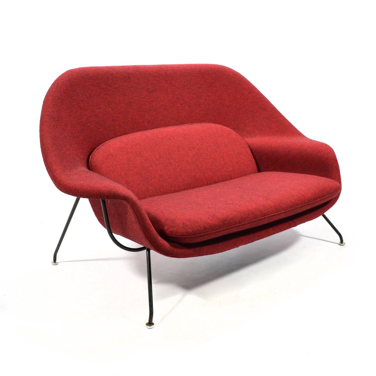 A fantastic example of Eero Saarinen's iconic design in rare large settee or sofa size. Saarinen designed the sofa variation in 1950 to accompany the womb chair. The piece is upholstered in Alexander Girard fabric which is a cross-weave of red and