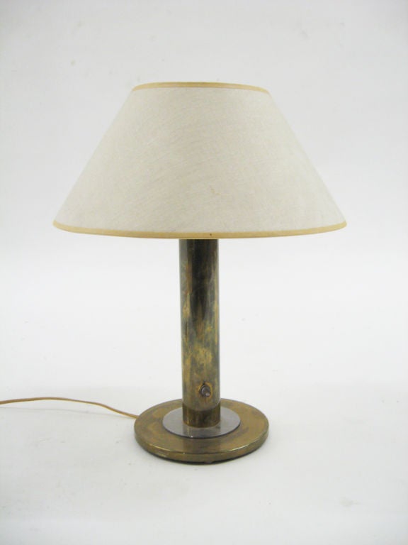 This fantastic early Nessen table lamp has a rich patina to the brass base that only comes with age. The original milk-glass diffuser supports the shade.