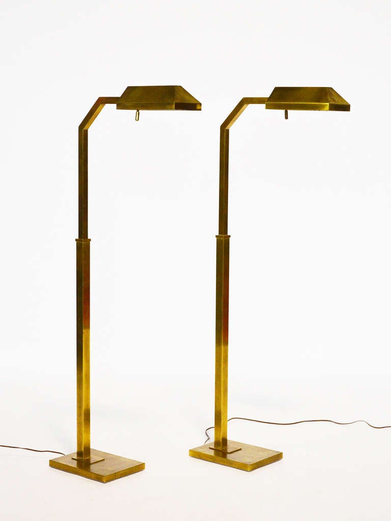 This handsome pair of reading lamps by Chapman have a strong architectural quality. The height is adjustable and the lamps have built in rheostats which allow the light to be adjusted to the desired level.