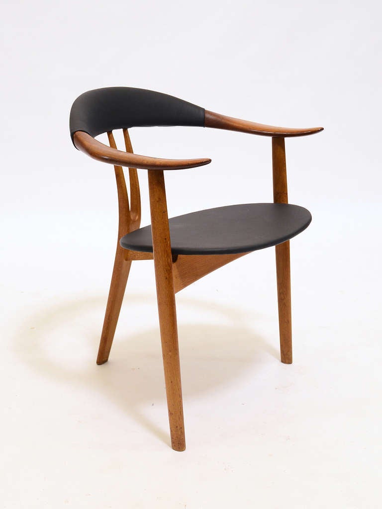 A gorgeous chair that epitomizes Scandinavian design, this armchair by Arne Hovmand-Olsen exhibits both fine craftsmanship and sculptural elegance. An occasional chair that is beautiful from every angle, the three legged form offers a wide,