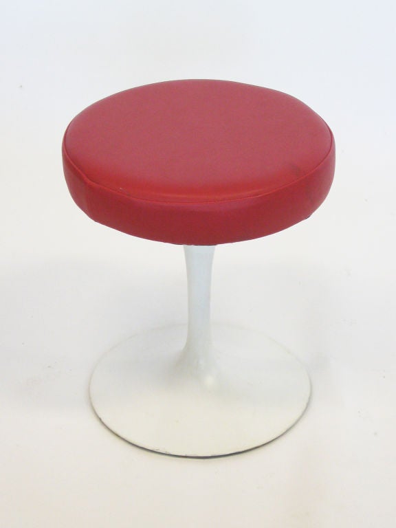 A nice example of Saarinen's timeless design, this tulip stool sports the swivel function and bright red leather upholstery.