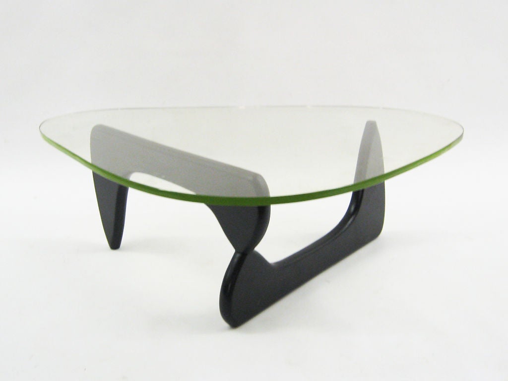 The iconic design by Isamu Noguchi is considered by many to be the most beautiful coffee table ever designed. The sculptor created a perfectly balanced composition of two identical wood forms to support a thick glass top with a free shape. Not