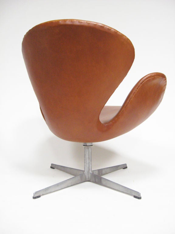 Danish Arne Jacobsen swan chair in cognac leather by Fritz Hansen