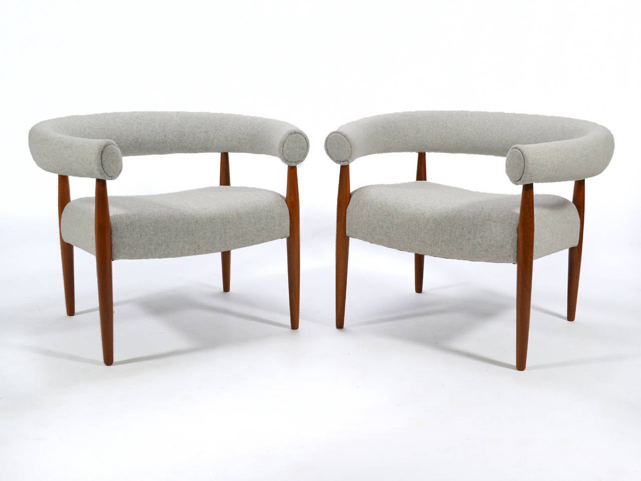 Designed in 1958 by Nanna and Jørgen Ditzel, the Ring chair (also called the Sausage chair) is a Classic Ditzel design. Circular in form, the arms and back are one piece which wraps around the sitter. The legs connect the back to the floating seat
