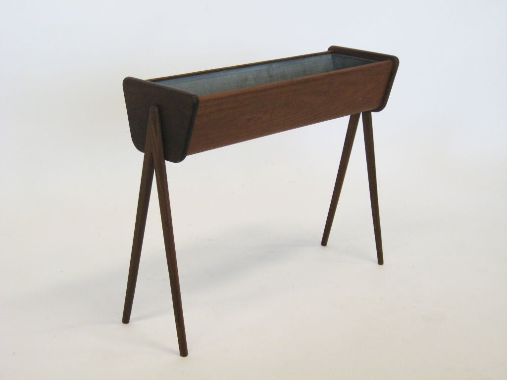 This elegant planter is a dramatic way to incorporate greenery into an interior. The sculptural legs support a planter with a galvanized steel insert. Perfect for in front of a window or adjacent to a seating group.