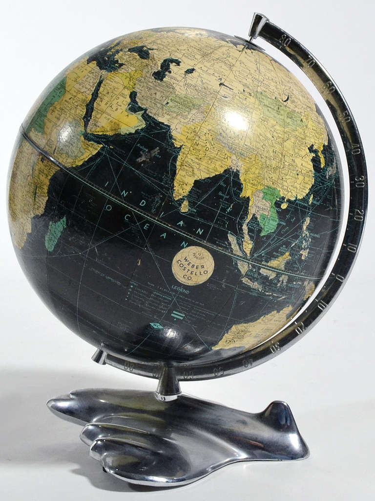 One of the most dynamic and desirable vintage globe designs, this wonderful piece has the striking black oceans and a chrome base in the form of a stylized airplane. It is in very good original unrestored condition.