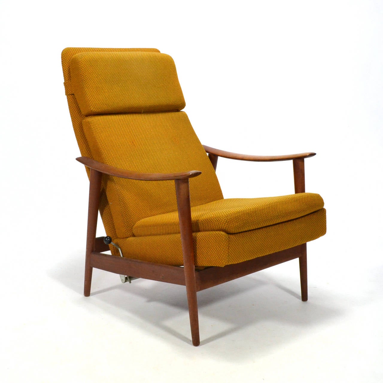 This lovely lounge chair with an external frame of teak has an upholstered seat and back which reclines and can be locked in different positions. It is very comfortable, and with the tapered legs and rakish arms, very stylish. The design shares