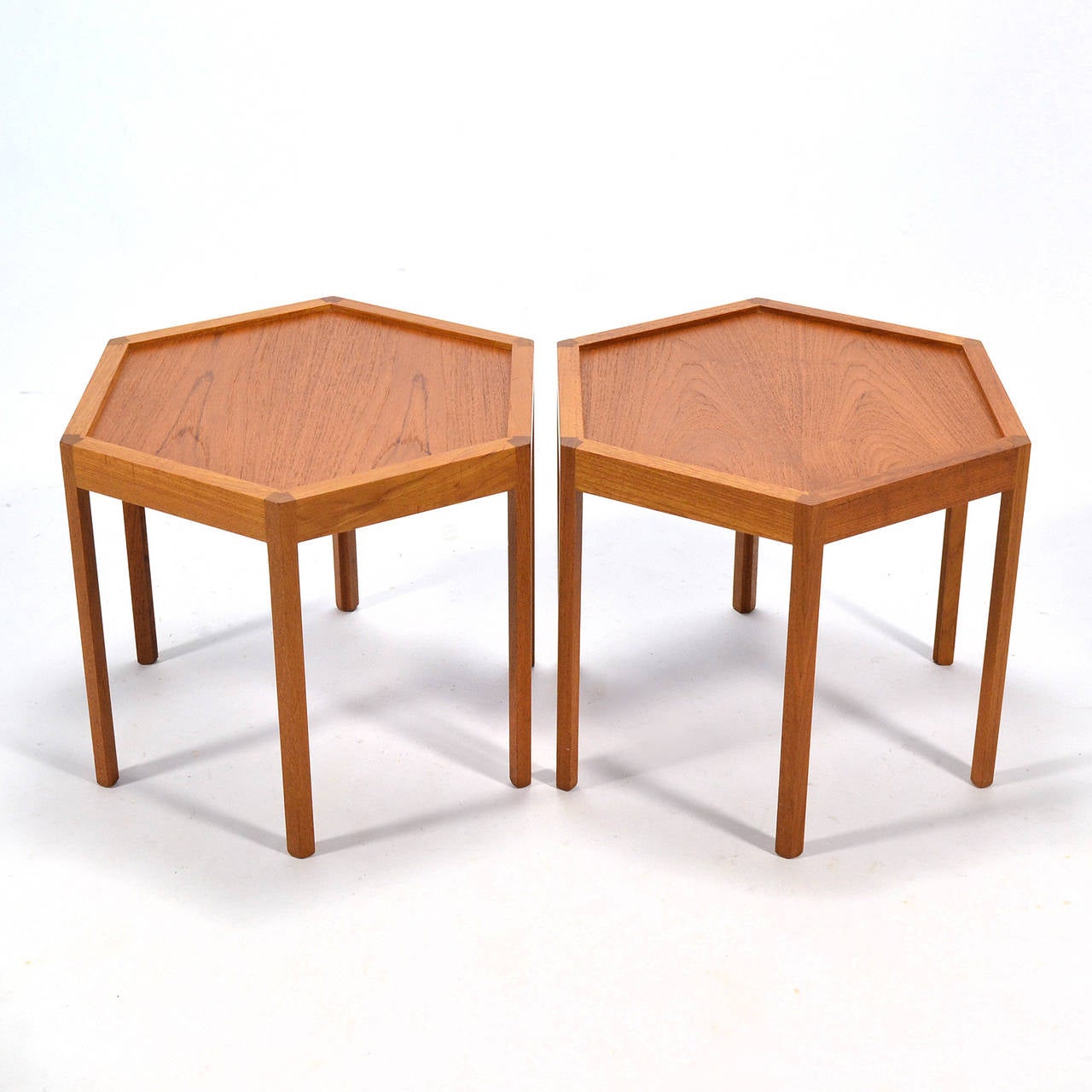 An outstanding example of Danish design and craftsmanship, these two hexagonal side tables by Hans Christian Andersen are delightful. The lightly scaled tables are filled with subtle details and stack easily if needed. They function perfectly as