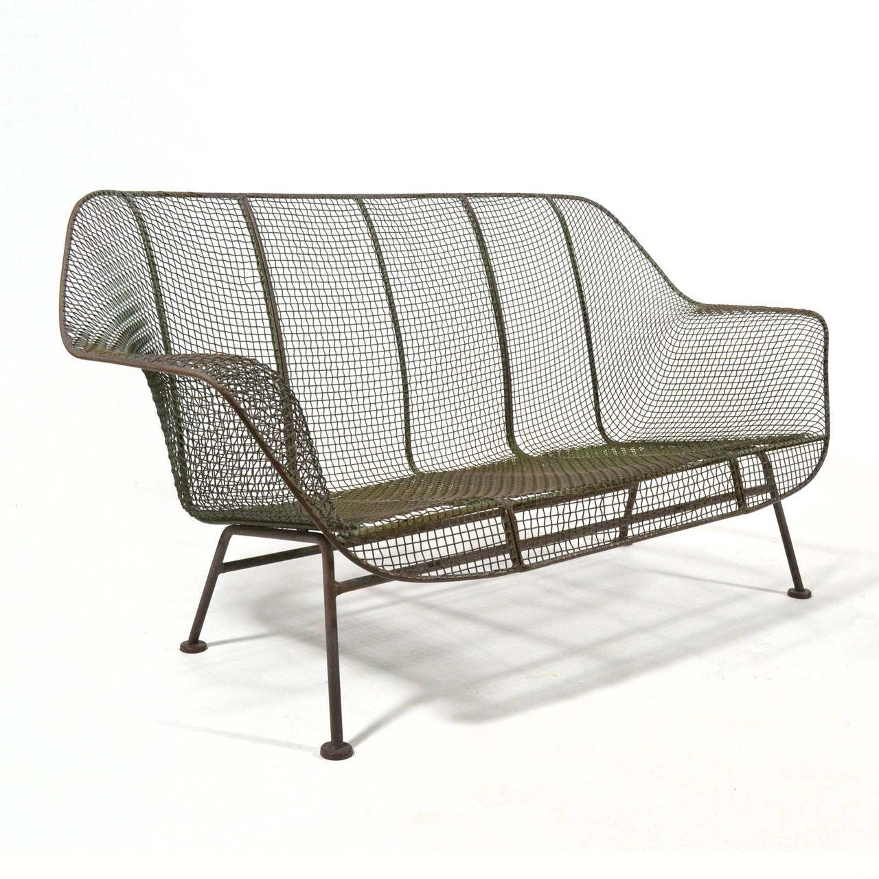 The Sculptura line by Russell Woodard is an enduring design for comfortable and long-lasting modern outdoor furniture. The wrought iron frame covered in sculpted wire mesh references the organic designs of Eames and Saarinen and parallels their