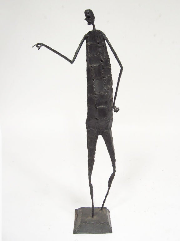 This compelling sculpture of a figure standing and pointing obviously owes a debt to Giacometti with its slender, elongated limbs and imposing countenance.