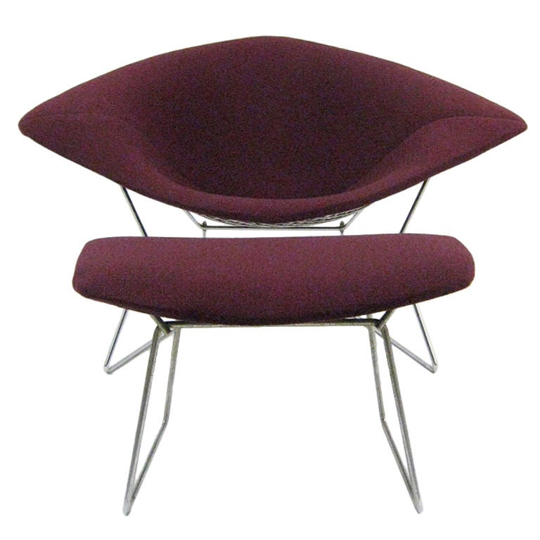 The wide diamond is the largest of the Bertoia seating group and like the bird chair, has shock mounts between the seat and the base which offers an additional measure of comfort. This vintage chair and ottoman has new Knoll covers in a wine color.