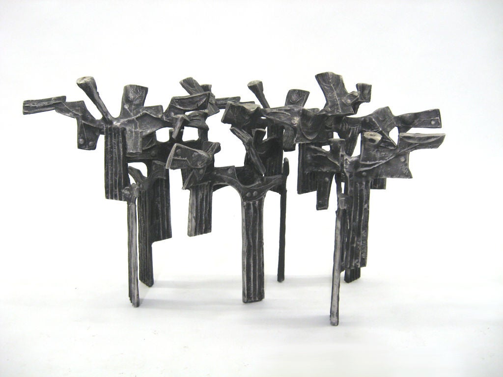 This remarkable piece by Donald Drumm is as much a sculpture as it is candelabra. Cast in aluminum with a rich patina and organic textural details it is reminiscent of a cluster of trees in the forest. An amazing piece with terrific presence.