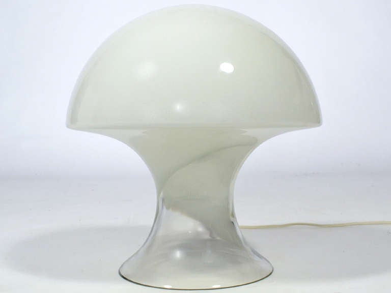 A great form executed in clear and milk white glass, This hand blown glass lamp is beautiful off or on. 

The Gino Vistosi design is deceptively simple with a minimal glass body concealing the light source. Expertly crafted in Murano Italy, it
