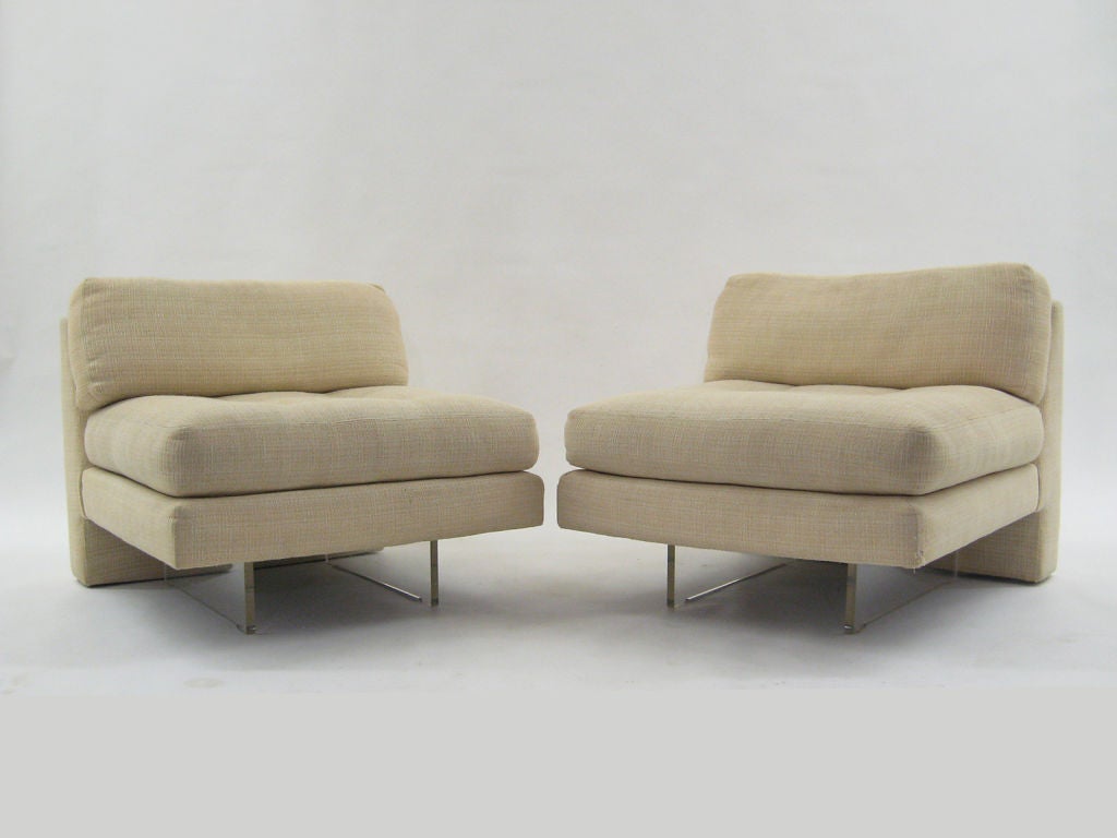 Two Vladimair Kagan Omnibus slipper chairs en suite with an ottoman/ bench.